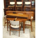 A Danish teak dining room suite, comprising: a circular table on tapering legs, with two leaves, 220