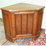 A low walnut corner cupboard fitted with a single door, 78cm wide, 69cm high.