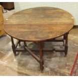 An antique oak gate-leg drop-leaf table with fitted end drawer, on turned legs, 146.5 x 120cm.