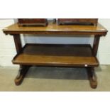 A late-19th century mahogany two-tier dumb waiter on carved end supports, 114cm wide, 78cm high.