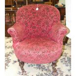 A Victorian stained wood salon chair on short turned legs and castors.