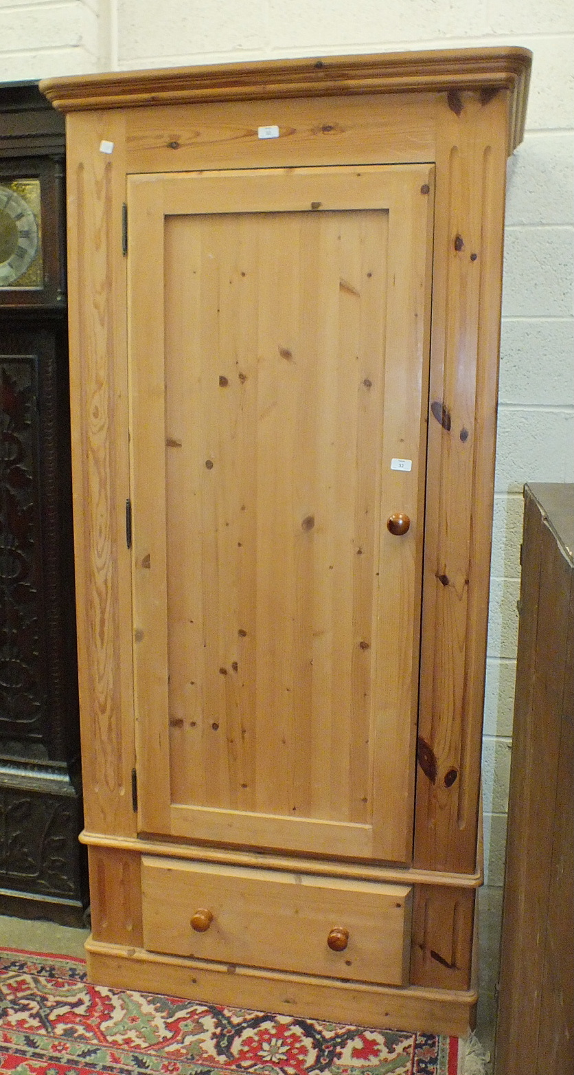 A modern pine single-door wardrobe on drawer base, 96cm wide.