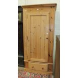 A modern pine single-door wardrobe on drawer base, 96cm wide.