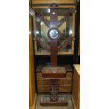 A Late-Victorian stained mahogany four-branch hall stand with central circular mirror, glove box and