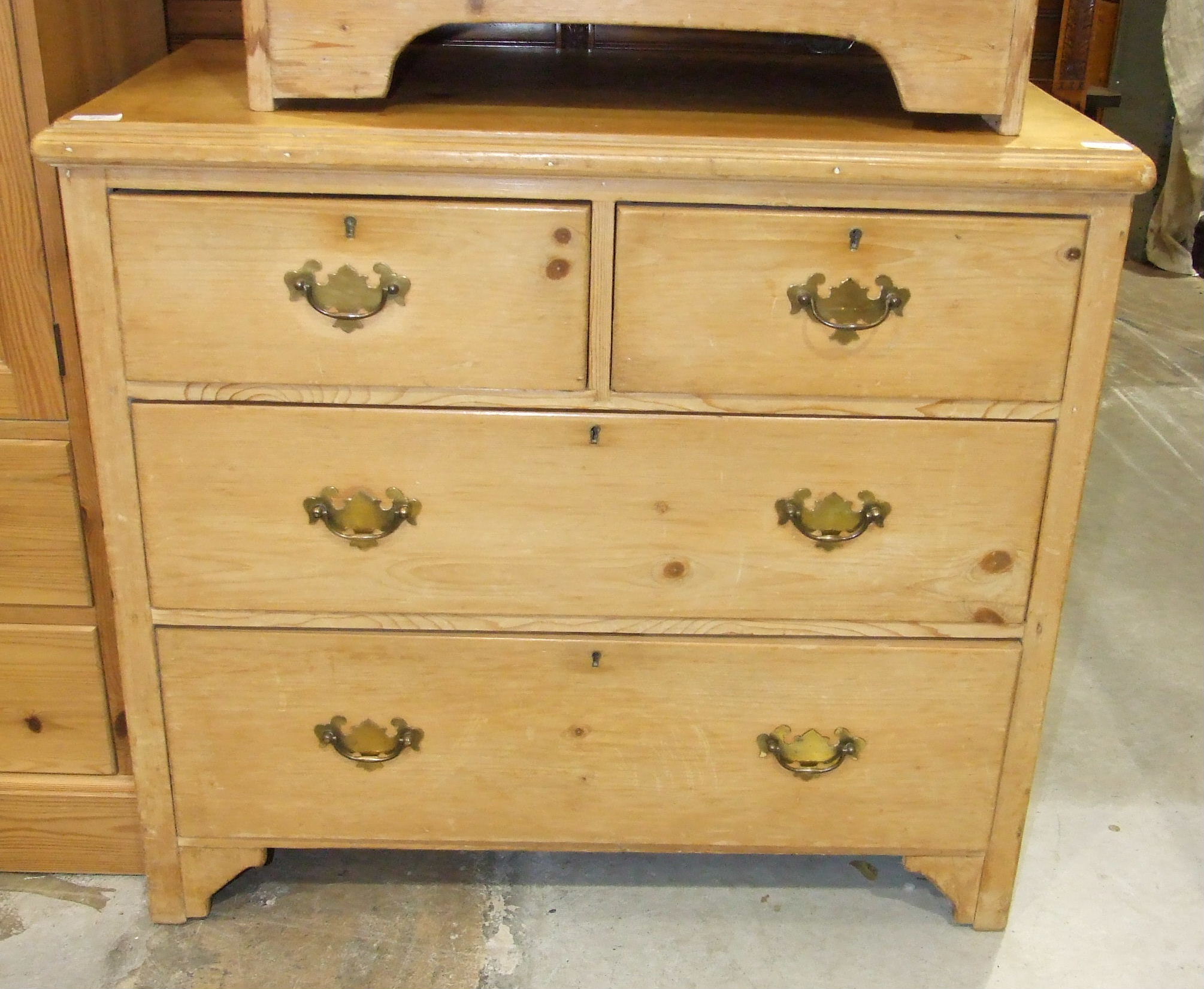 A stripped pine straight-front chest of two short and two long drawers, 90cm wide, 82cm high.