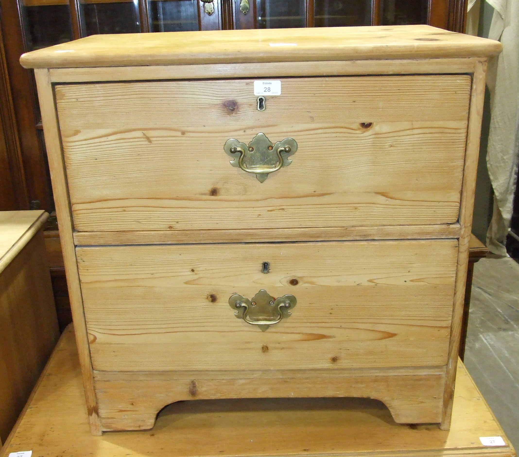 A low stripped pine chest of two drawers, 67.5cm wide, 68cm high.