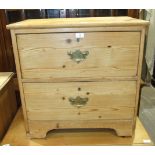 A low stripped pine chest of two drawers, 67.5cm wide, 68cm high.