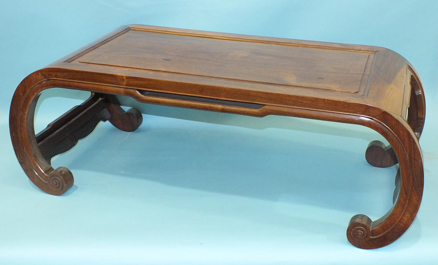 An Oriental hardwood rectangular opium table on scroll supports, 89 x 43cm.