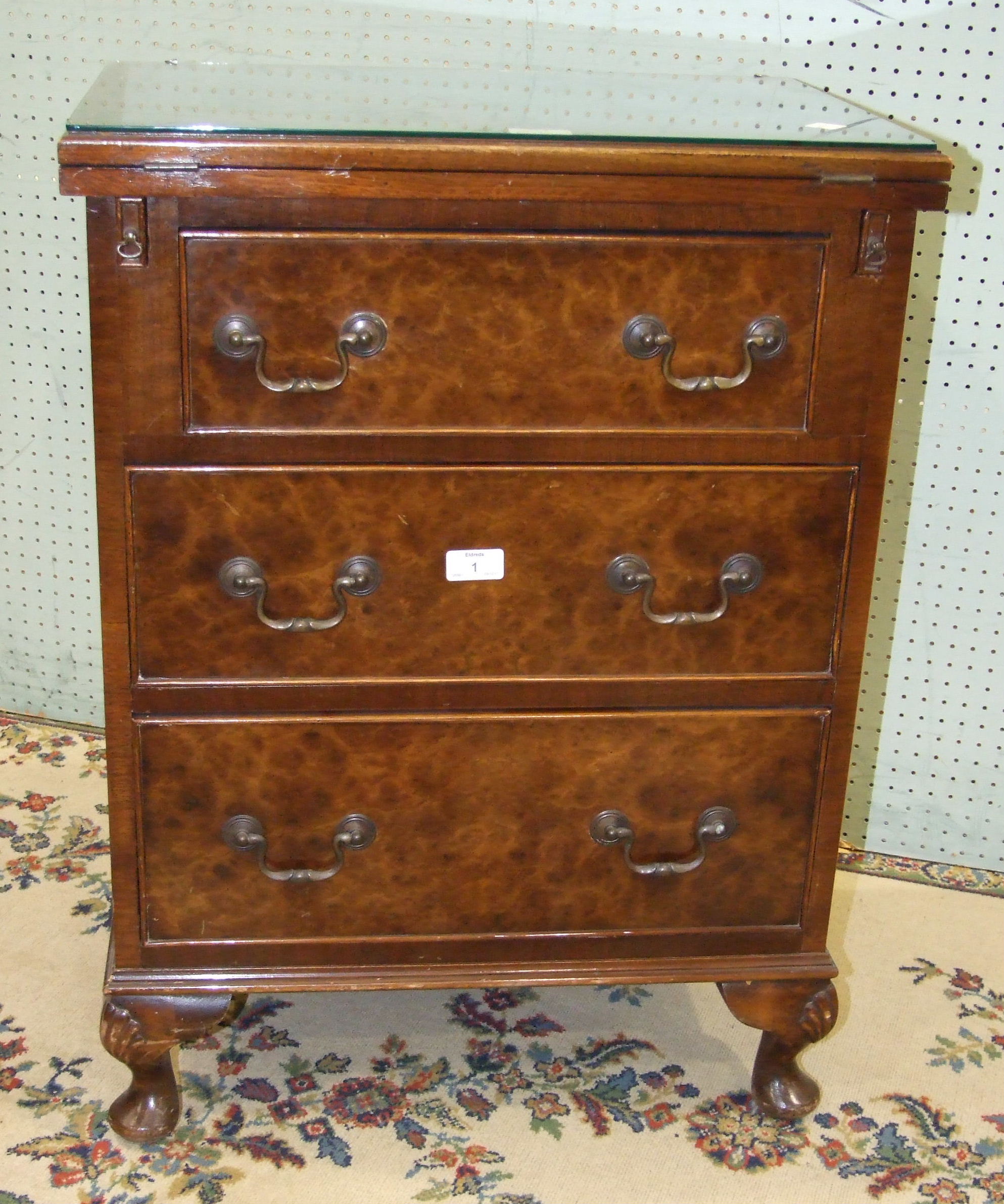 A 'Jaycee' low walnut bedside chest, the hinged rectangular fold-over top above three drawers, on