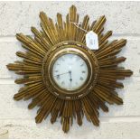 A gilt 8-day sunburst clock with French movement, 33cm diameter.