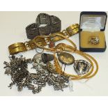 A silver charm bracelet, a filigree bracelet, a silver watch chain and other items.