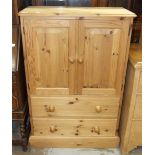 A modern pine low cupboard, the rectangular top above a pair of doors and two drawers, 76cm wide,