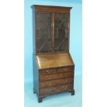 A Georgian bureau/bookcase, the dentil cornice above a pair of astragal-glazed doors, the fall front