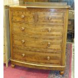 A late-19th century mahogany bow-fronted chest of two short and three long drawers, on turned