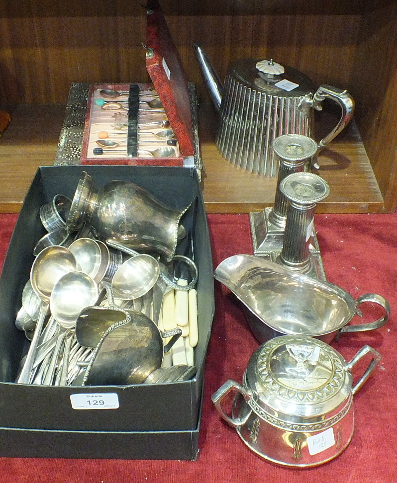 A pair of short reeded column plated candle sticks, 13cm high, a plated teapot, plated cutlery and