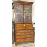 A mainly-18th-century oak bureau/bookcase having a pair of astragal-glazed doors above a fall