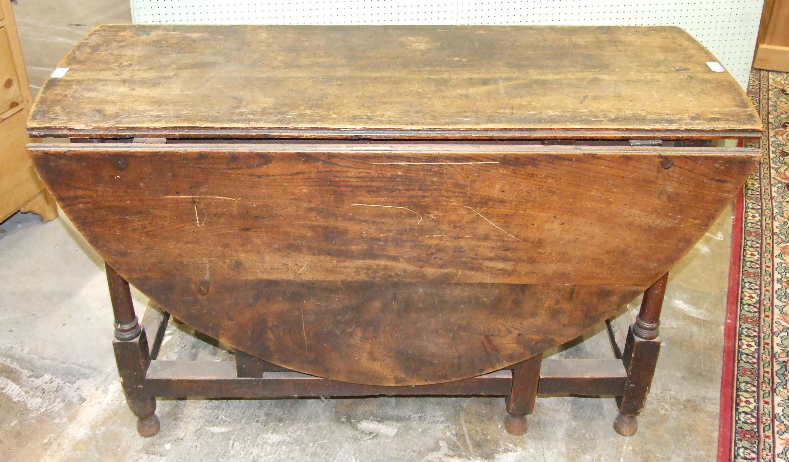 An antique oak gate-leg drop-leaf table with fitted end drawer, on turned legs, 146.5 x 120cm. - Image 2 of 2