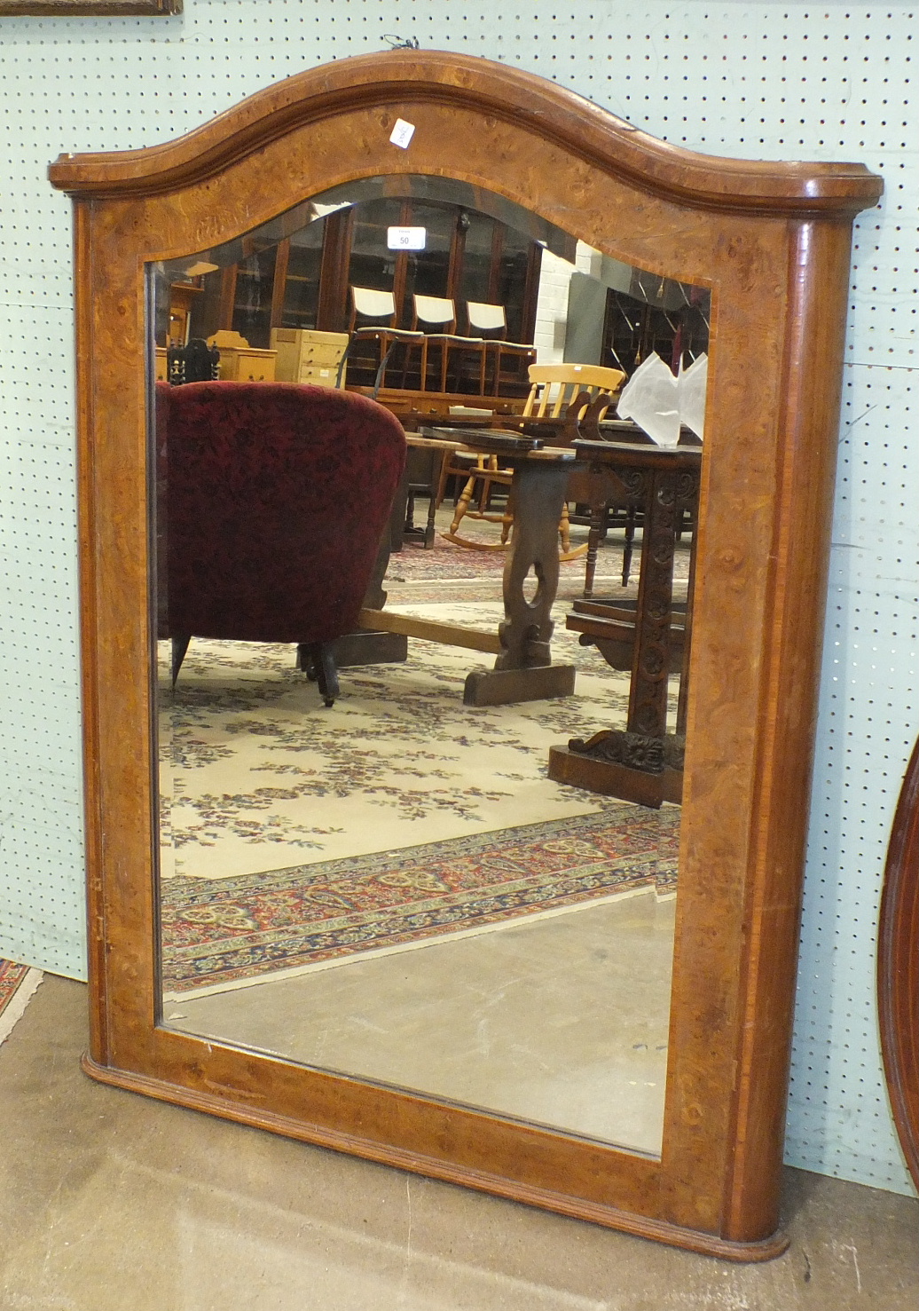 A 19th century French burr walnut cross-banded pier mirror, the arched corniced frame enclosing a