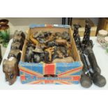 A large collection of carved wood animals, including elephants, hares, etc. and a pair of tribal