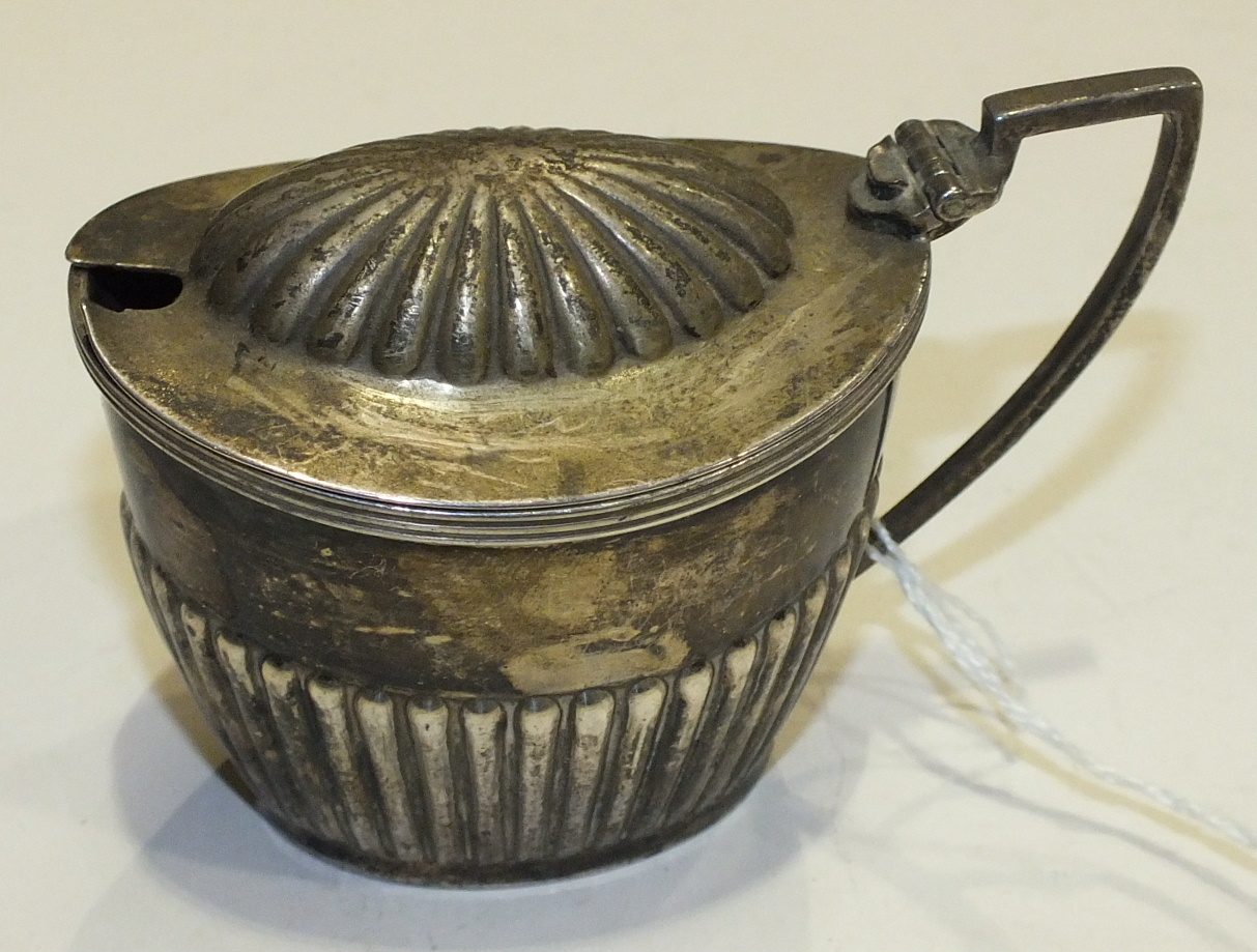 A silver mustard pot of half-gadrooned form, London 1906, ___3oz, (no liner).