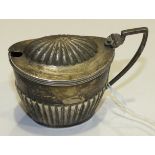 A silver mustard pot of half-gadrooned form, London 1906, ___3oz, (no liner).