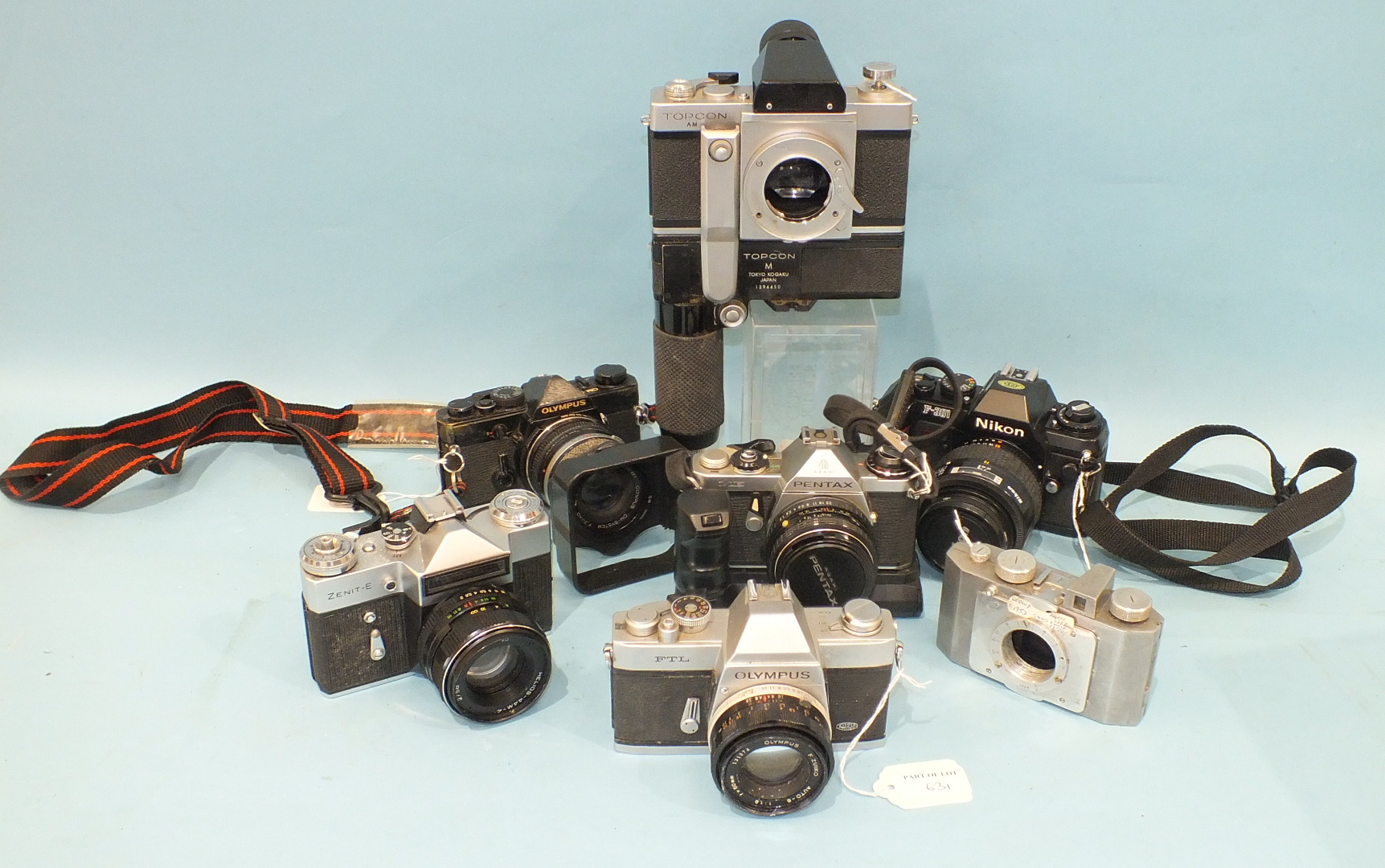 Seven SLR cameras: Top con.AM Olympus OM-1 and FTL, Pentax ME, Nikon F-301, Zenit-E and a 1952