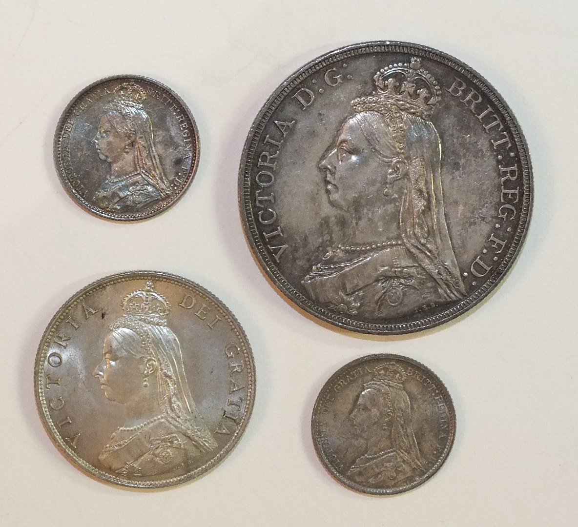 A Victoria 1887 crown, 1887 florin and two 1887 sixpences, (4).