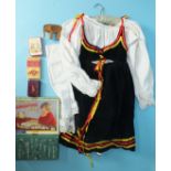 A child's dirndl dress and blouse, two map jigsaws (unchecked), playing cards and other items.