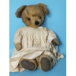 An English post war teddy bear, possibly J K Farnell, with gold plush, large ears, stitched nose,