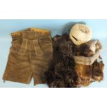 A pair of leather lederhosen, an ermine muff, a faux fur coat, an ostrich boa and other items.