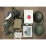 A collection of WWII webbing, water bottle, tin helmet, American tin helmet and a photograph of