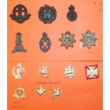 A large collection of Staybright British Army cap badges, including Royal Army Chaplain badges,