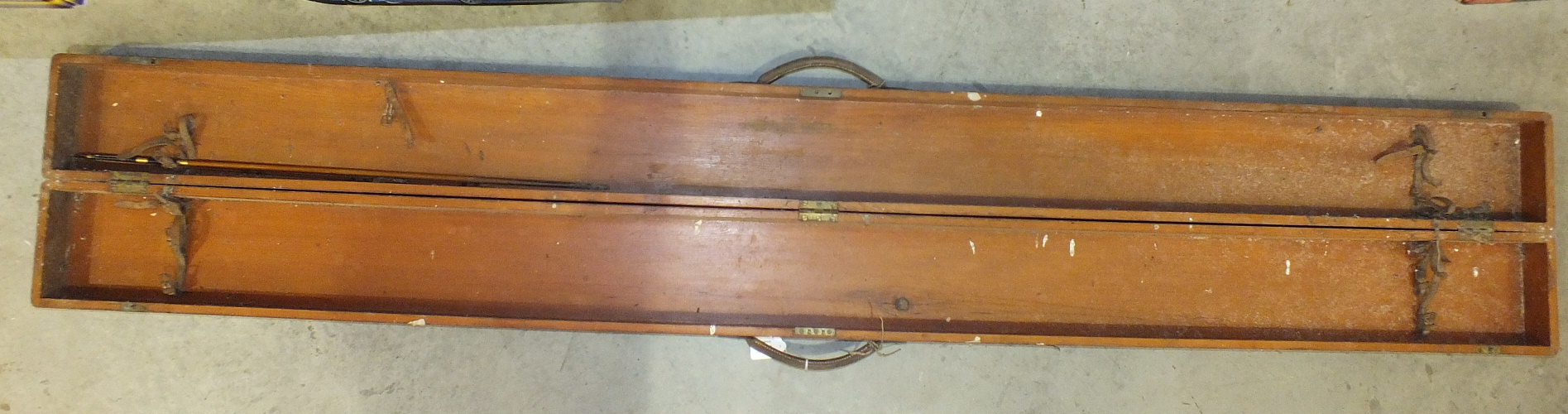 A 19th century stained pine fishing rod box with triple hinges, leather rod straps and leather