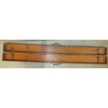 A 19th century stained pine fishing rod box with triple hinges, leather rod straps and leather