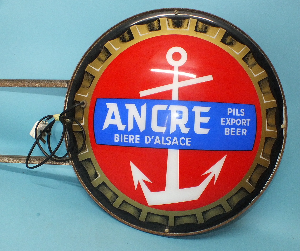 An "Ancre Pils Export Beer" sign in the form of a bottle top, illuminated, 60cm diameter.