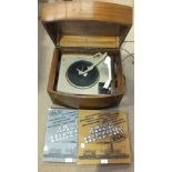 A Pye 'Black Box' record player in mahogany finish case and two records, Jazz History Vols I and