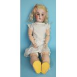 An early-20th century German bisque head doll with sleeping brown eyes, open mouth with teeth,