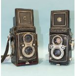 A Yashica-Mat Copal MXV twin-lens reflex camera with part of leather case, (a/f) and another,