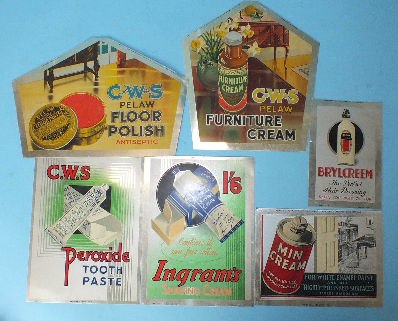 Six tin advertising signs including three CWS signs for polish and toothpaste, various sizes and