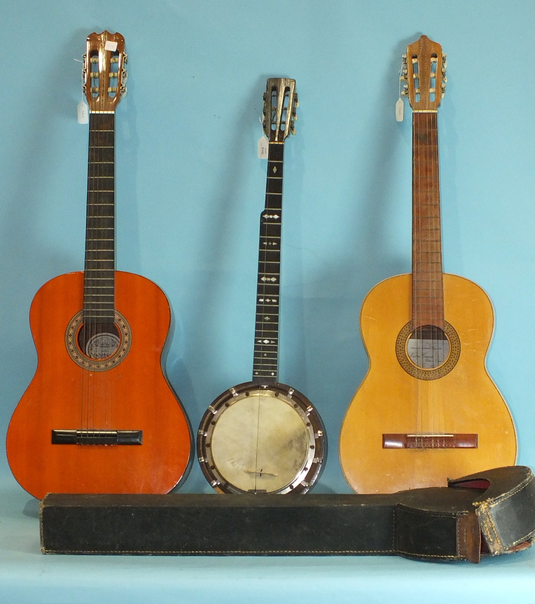 A Victor Garcia six-string guitar, a Hondo model H308-1 six-string guitar and a banjo stamped "