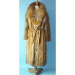 A full-length fur coat with leather belt, possibly fox.