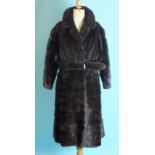 A dark mink full-length coat with belt.