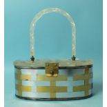 A 1950's woven metal handbag of oval shape with incised clear Lucite lid and handle, 21cm long.