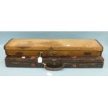 A leather-bound oak gun case in poor condition and a canvas-covered case, (2).