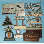 Thirteen various card and tin advertising signs, mainly for clothing.