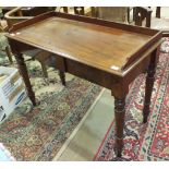 A Victorian two-drawer side table with galleried rectangular top, on turned legs, 112cm wide.