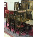 An oak refectory-style dining table and eight chairs.