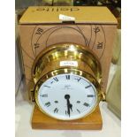A Schatz 'Royal Mariner' brass circular ship's clock, 18cm diameter, mounted on wooden stand with