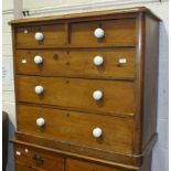 A Late-Victorian stained pine straight-front chest of two short and three long drawers, with