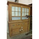 A late-19th/early-20th century stripped pine dresser, the upper shelved section fitted with a pair